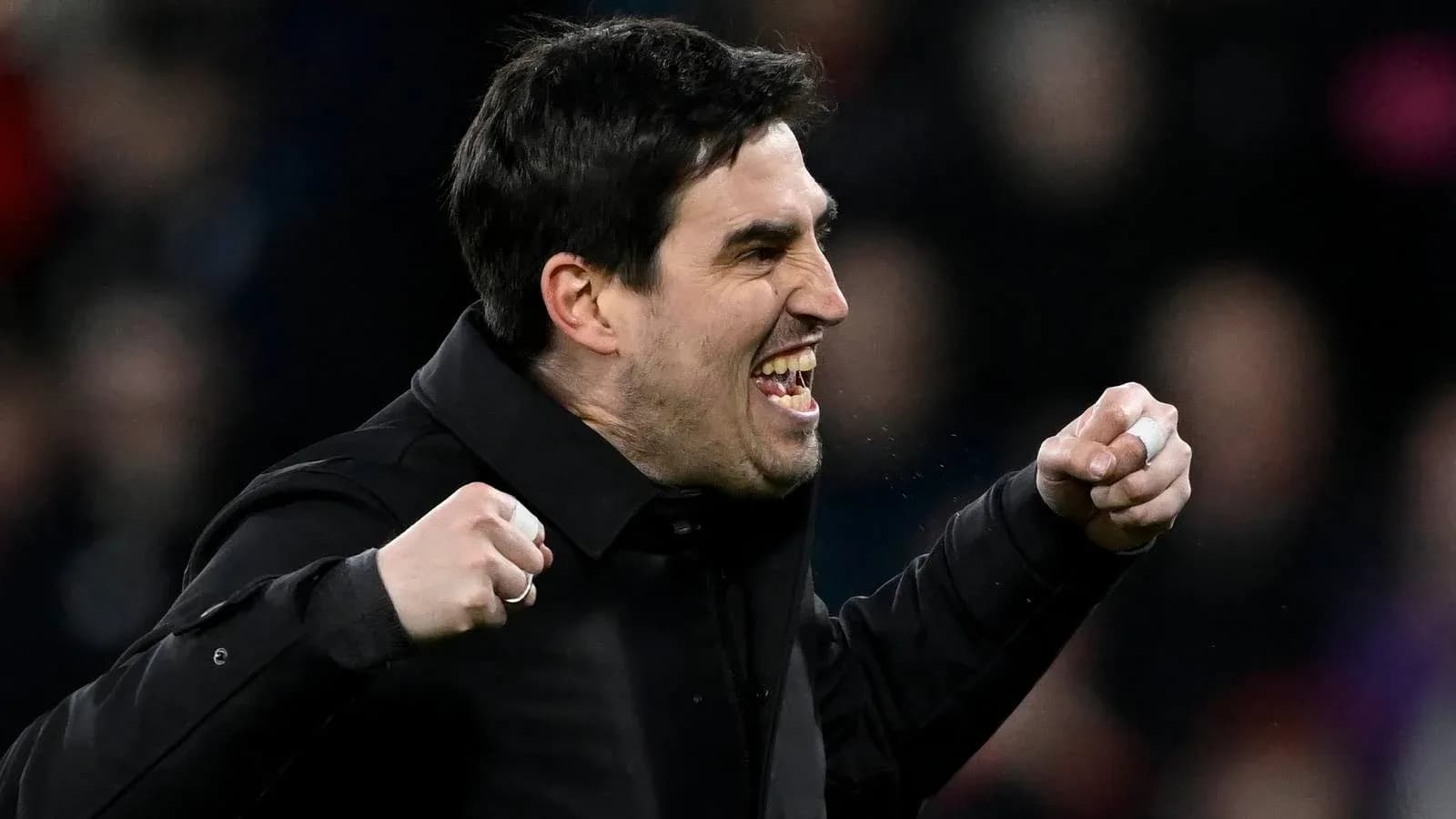 Coach celebrating passionately during a match