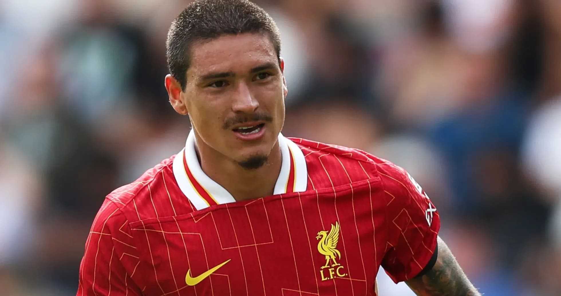 Player in Liverpool jersey running on the pitch