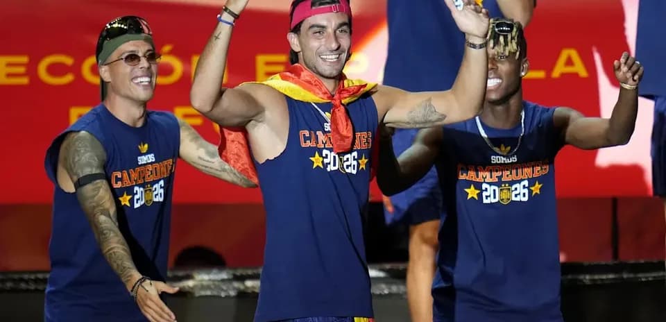 Players celebrating with a trophy on stage