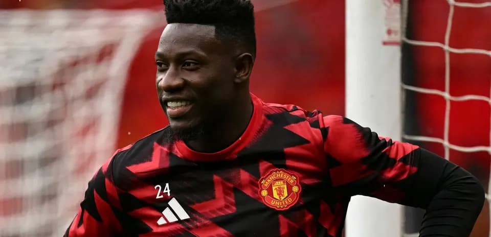 Goalkeeper in Manchester United training kit smiling