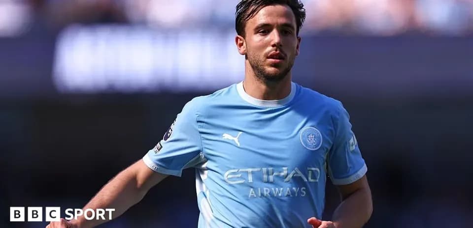 Player in light blue jersey running on the pitch