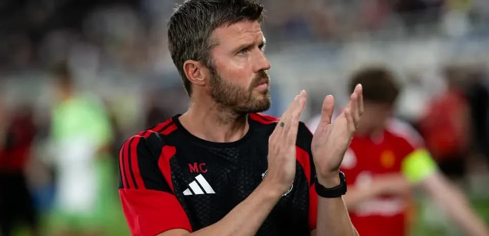 Coach applauding during warm-up on the field