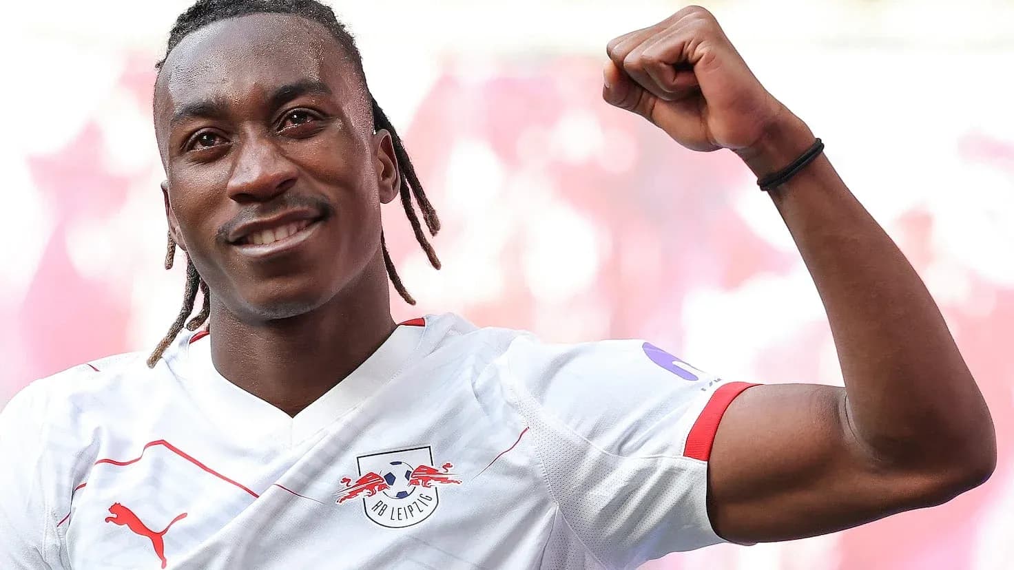 Player celebrating with raised fist in RB Leipzig jersey