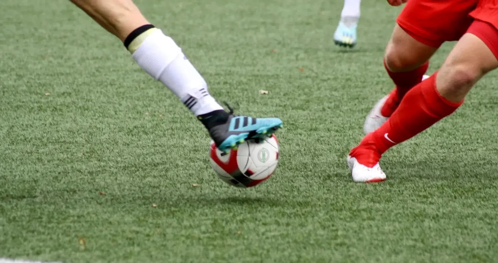 Players competing for the ball during football match