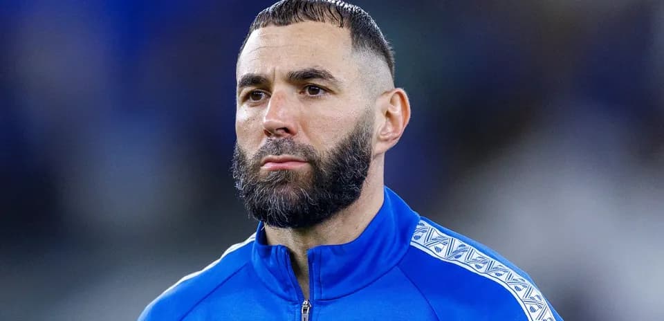 Player in blue jacket during match preparation