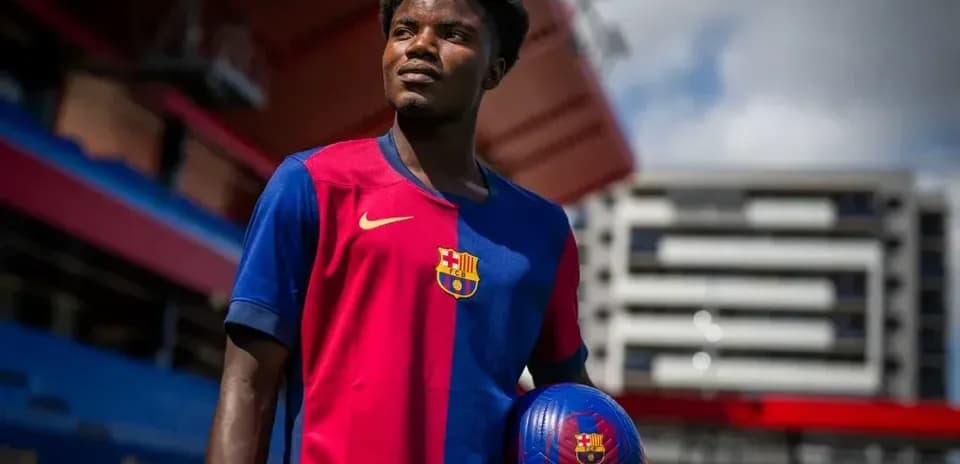 Player posing in FC Barcelona jersey with ball