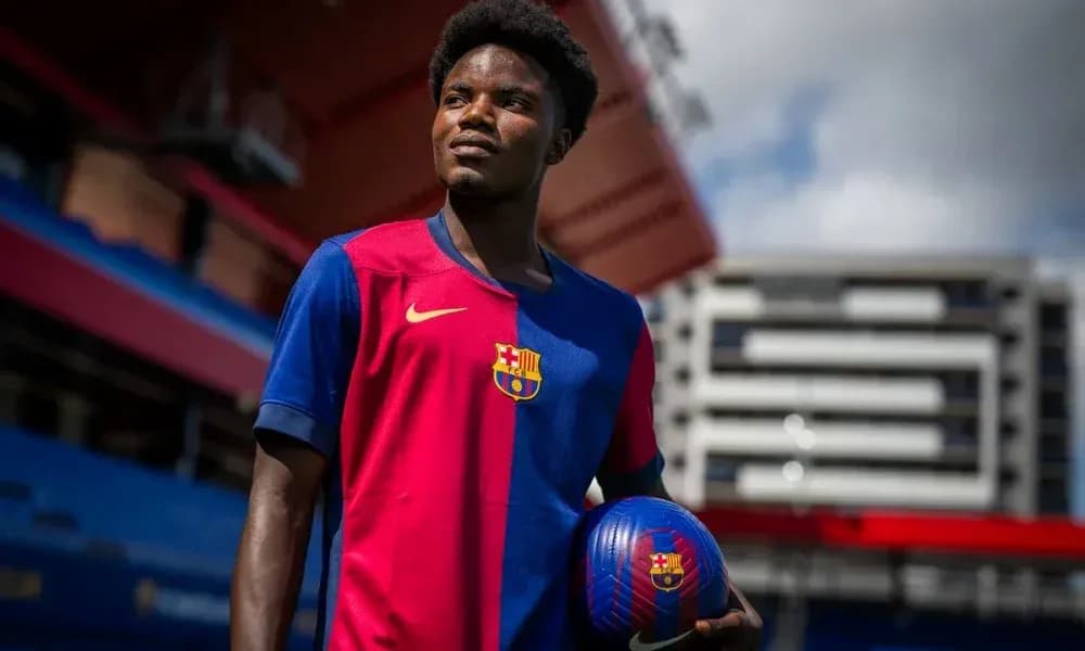 Player posing in FC Barcelona jersey with ball