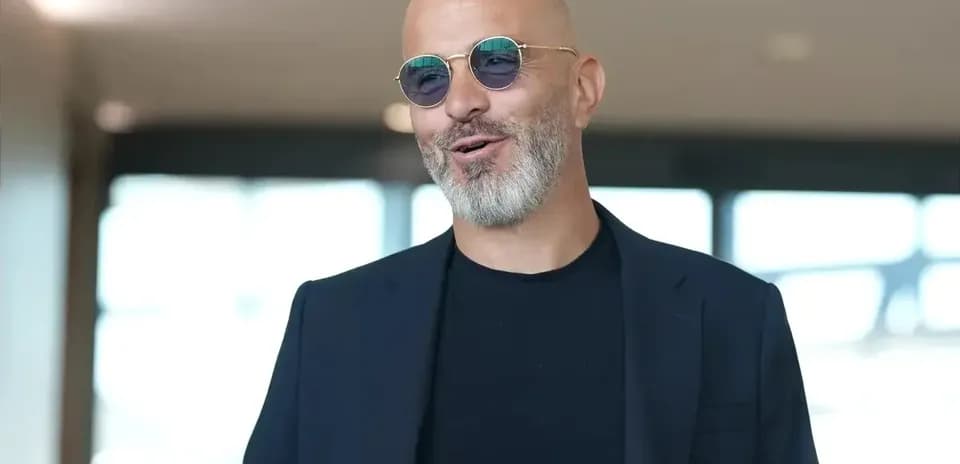 Man with glasses smiling in modern interior