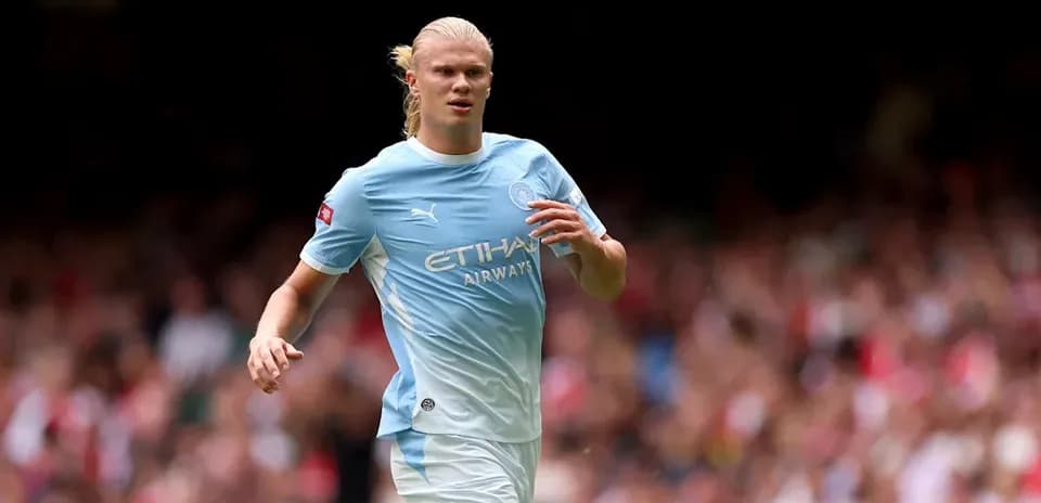 Player in light blue kit running on the field