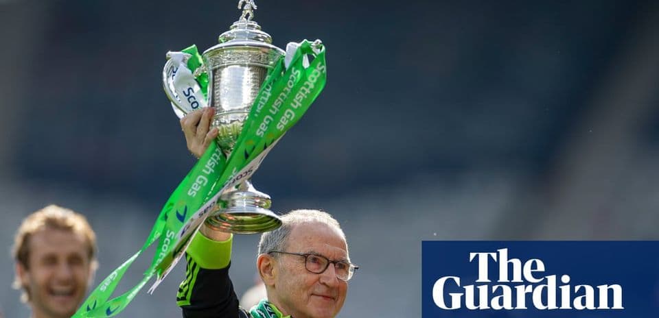Manager holding trophy with celebratory ribbon
