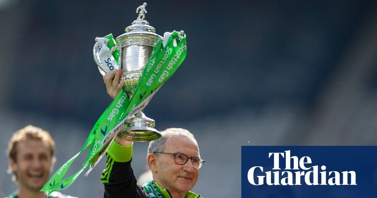 Manager holding trophy with celebratory ribbon