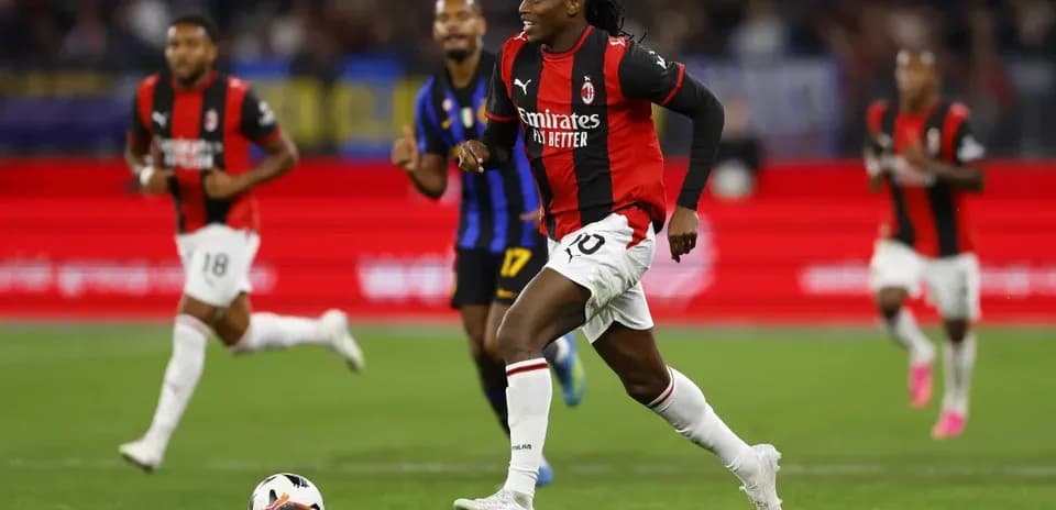 Player in AC Milan kit dribbling ball during match