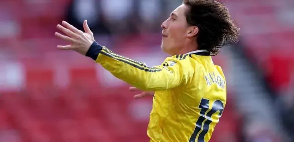 Player celebrating in yellow kit on the pitch