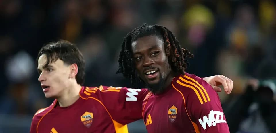 Two AS Roma players celebrating on the pitch