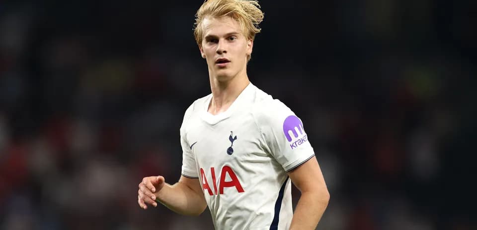 Player in Tottenham kit running on the pitch