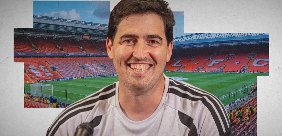Man smiling in front of Anfield stadium backdrop