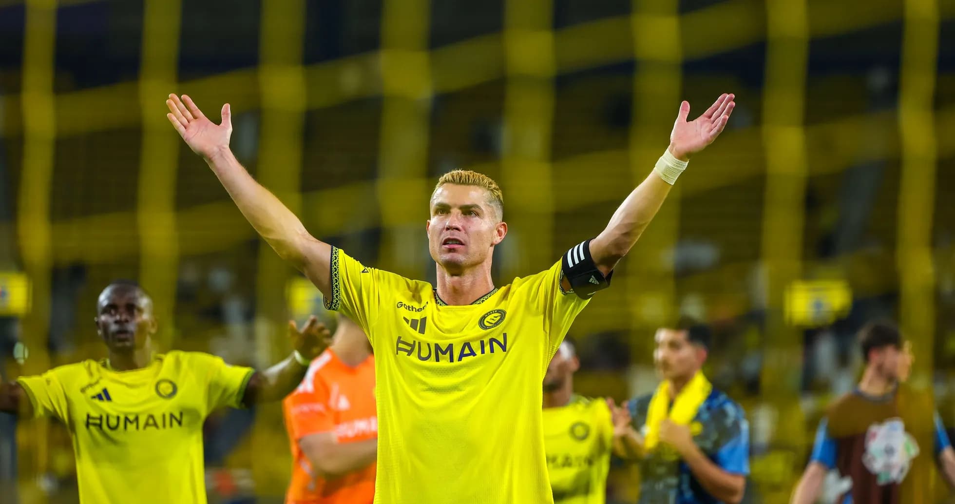 Player celebrating with arms raised after match