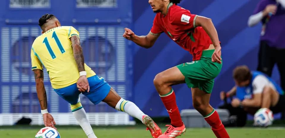 Player from Brazil dribbling past Moroccan defender