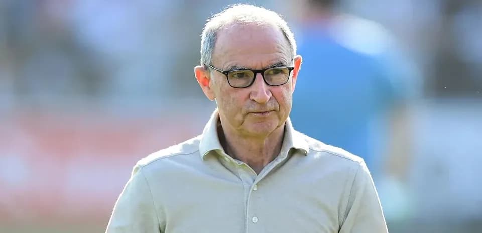 Man in glasses walking on a sports field