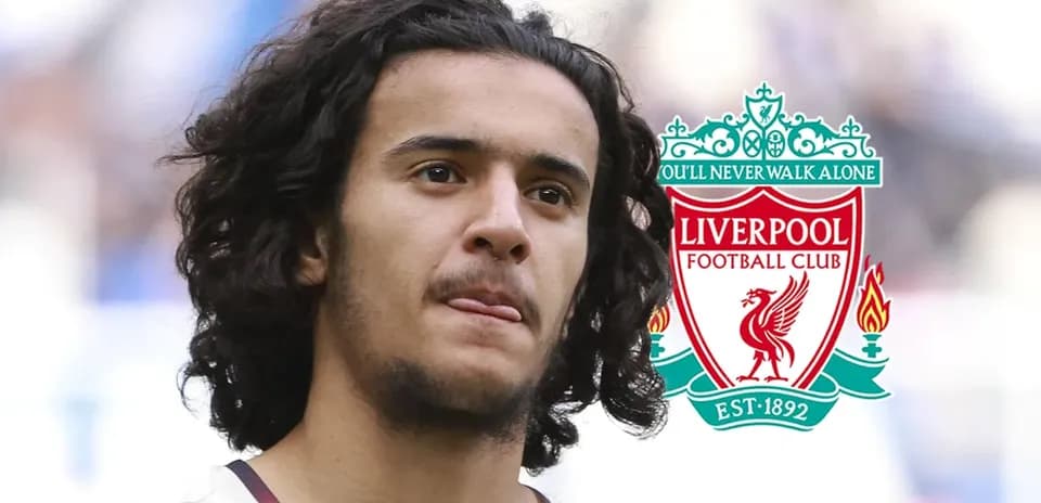 Player standing with Liverpool FC logo in background