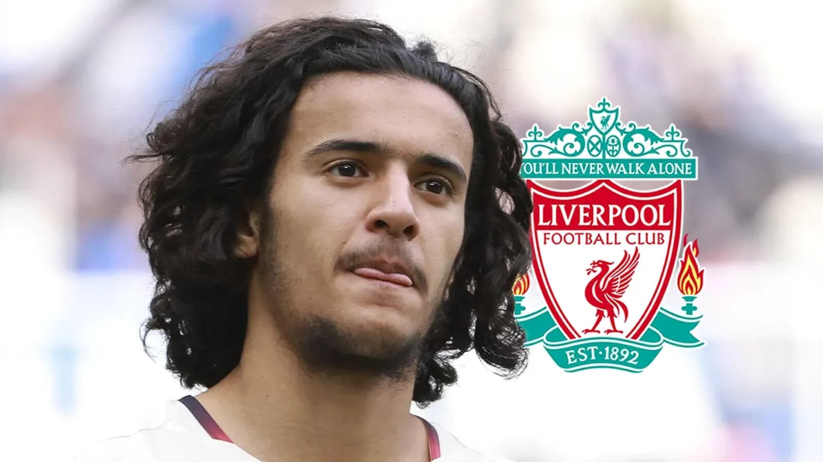 Player standing with Liverpool FC logo in background