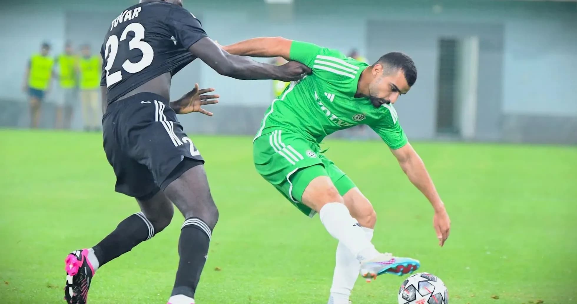 Player tackling opponent during Europa League match