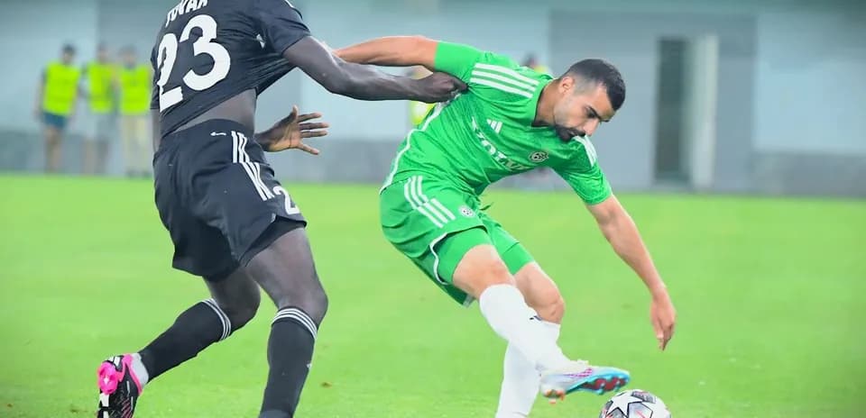Player tackling opponent during Europa League match