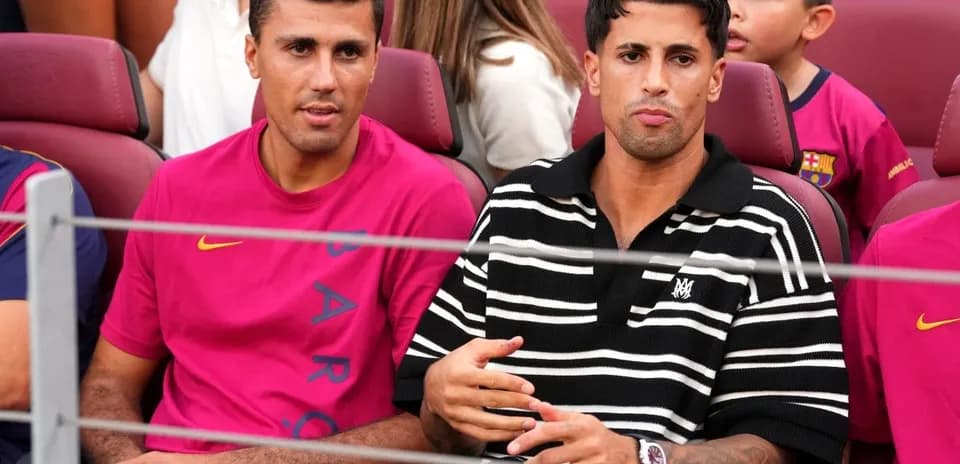 Two men sitting in stadium seats during event