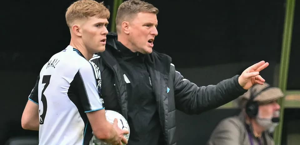 Newcastle player receiving instructions from coach during match