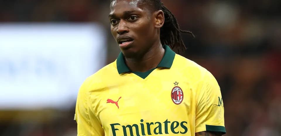 Player wearing yellow AC Milan jersey during match