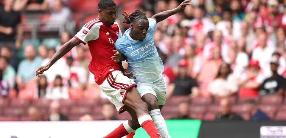 Two players battling for the ball during match