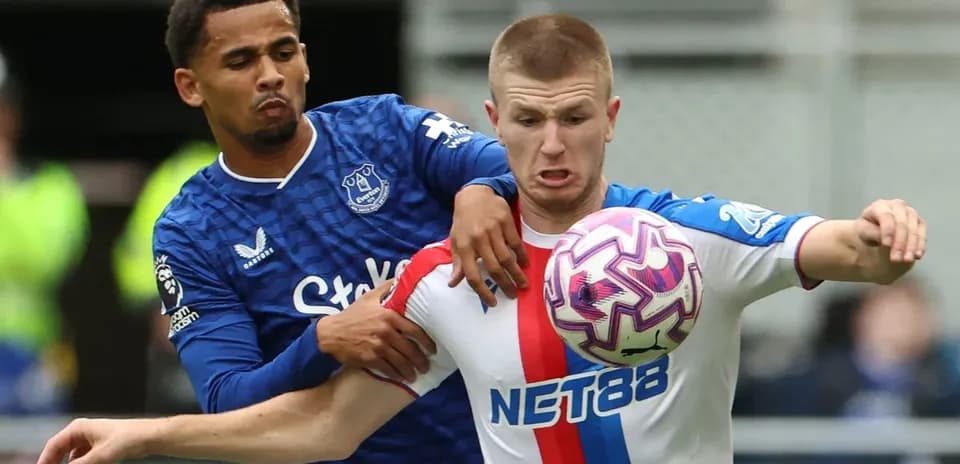Two players battling for possession of the ball