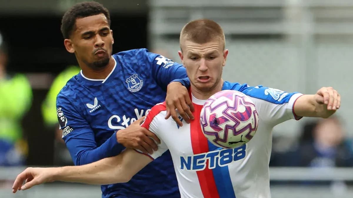 Two players battling for possession of the ball
