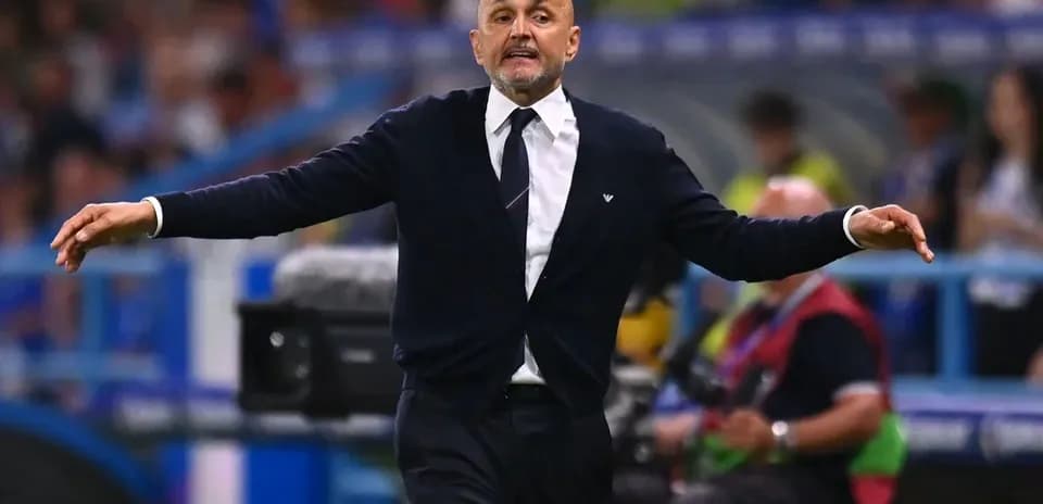 Coach gesturing during a football match on sidelines