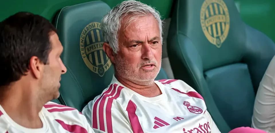 Coach and player seated on bench during match