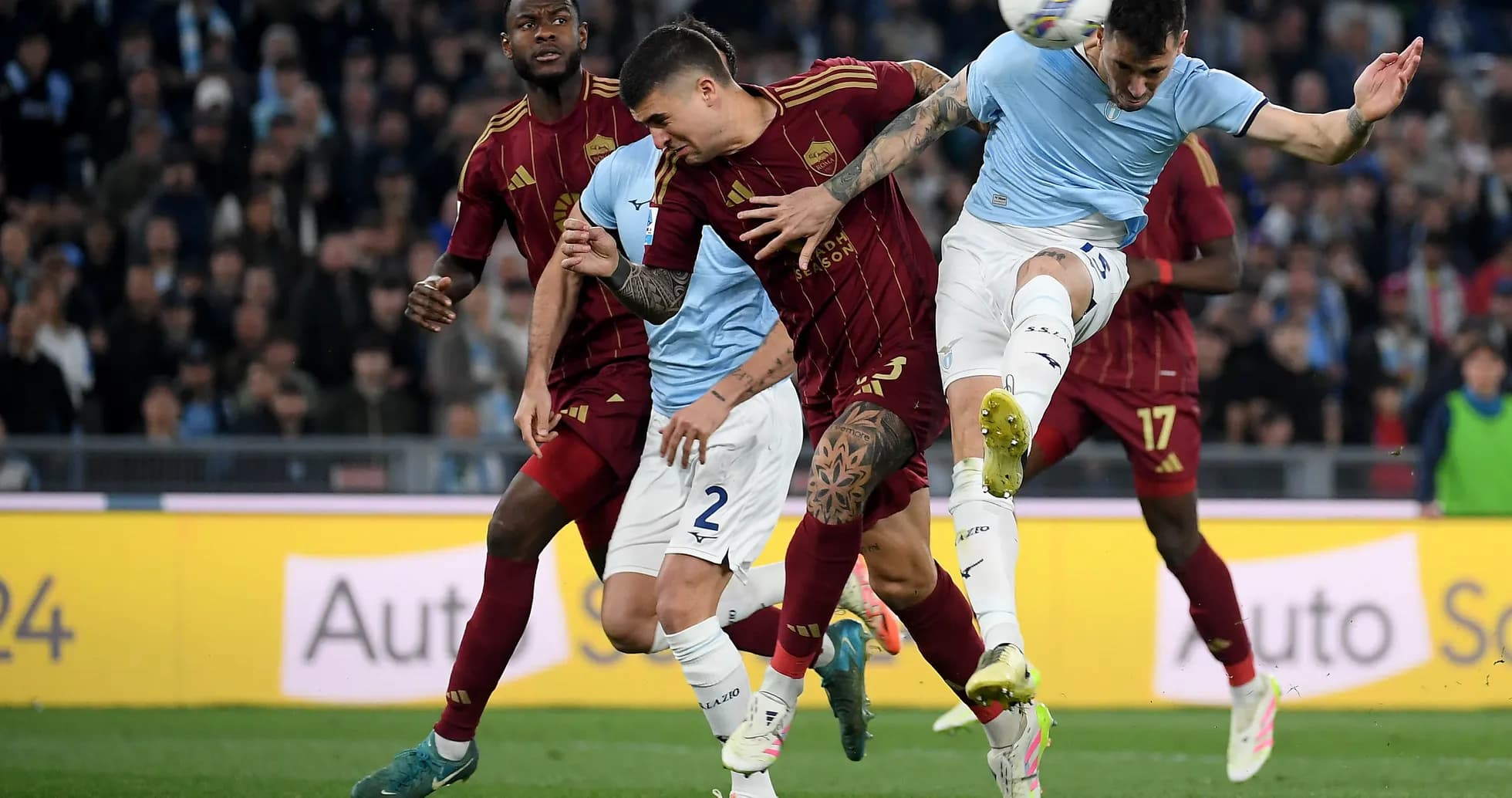 Players battling for the ball during Roma vs Lazio