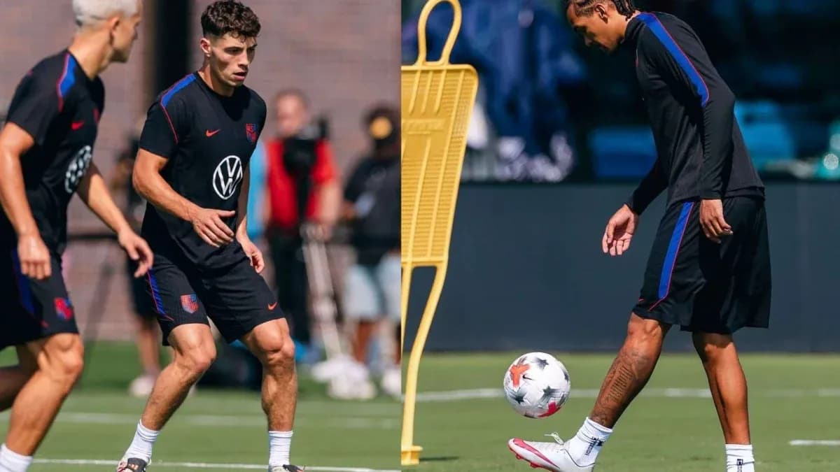 Two players training on the pitch with a ball Two players training on the pitch with a ball