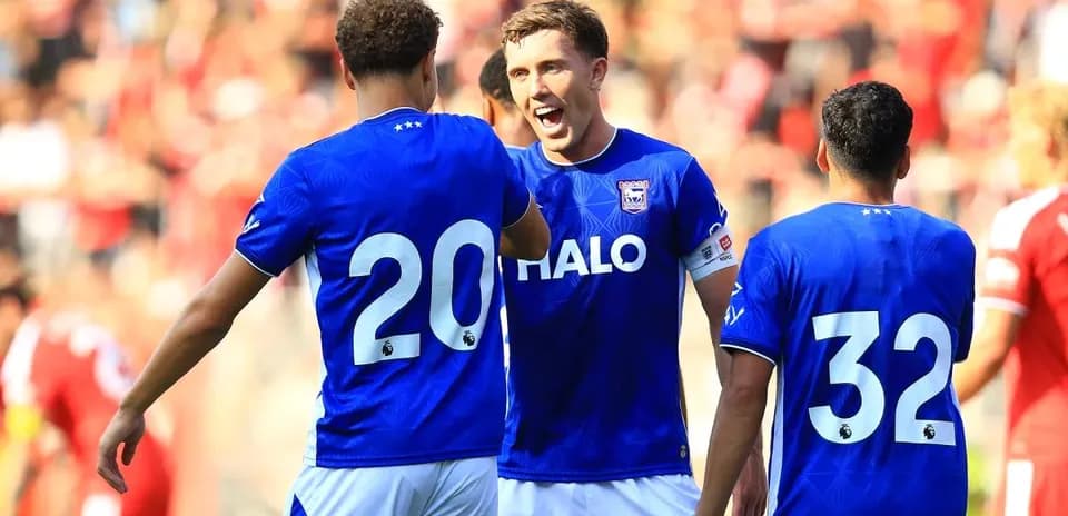 Three players celebrating during a football match