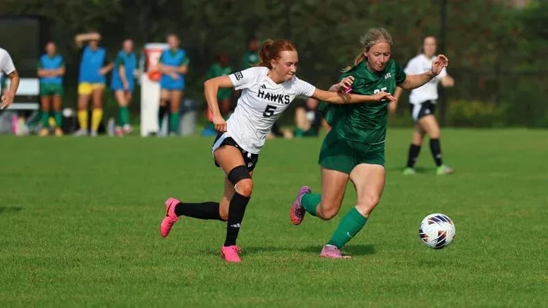 Player battling for the ball during soccer match