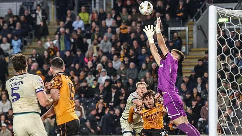 Goalkeeper catching ball during intense match moment