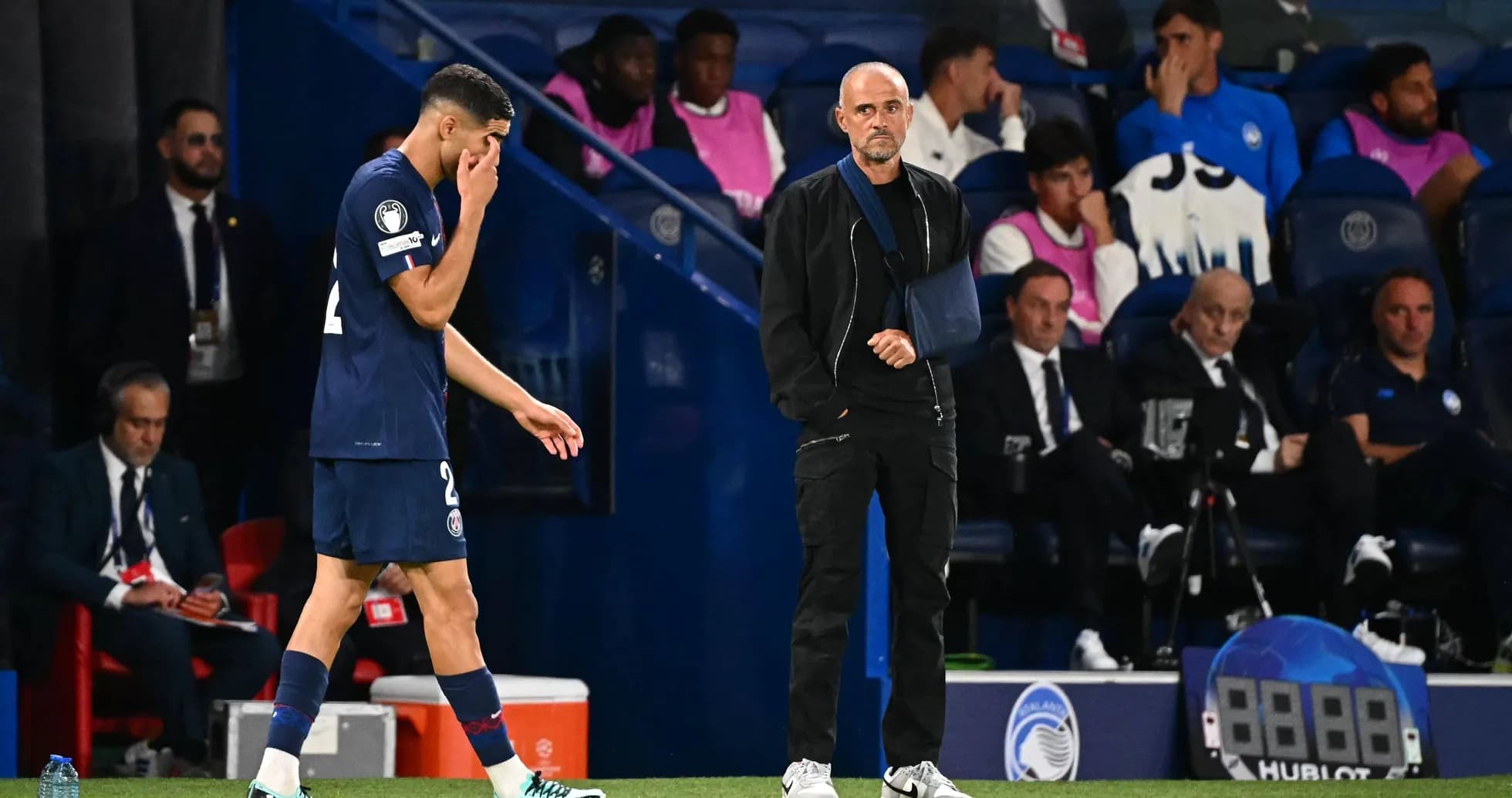 Player leaving pitch while coach observes from sideline