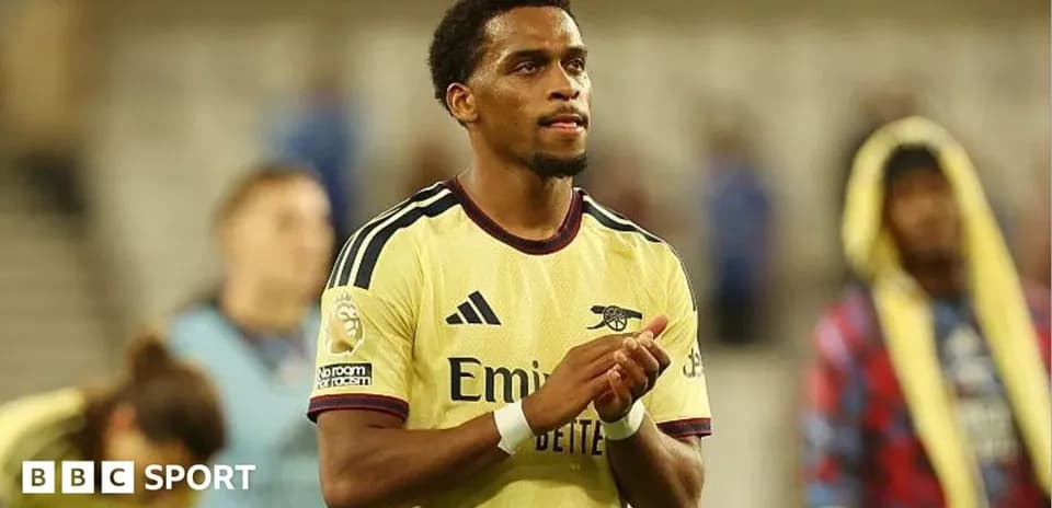 Player applauding fans after match wearing Arsenal jersey