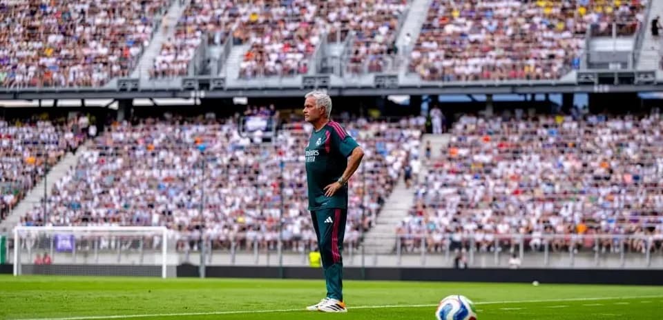 Coach standing on sideline during crowded match