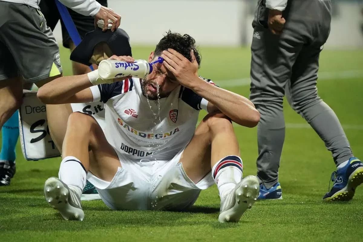 Player sitting on field pouring water on head