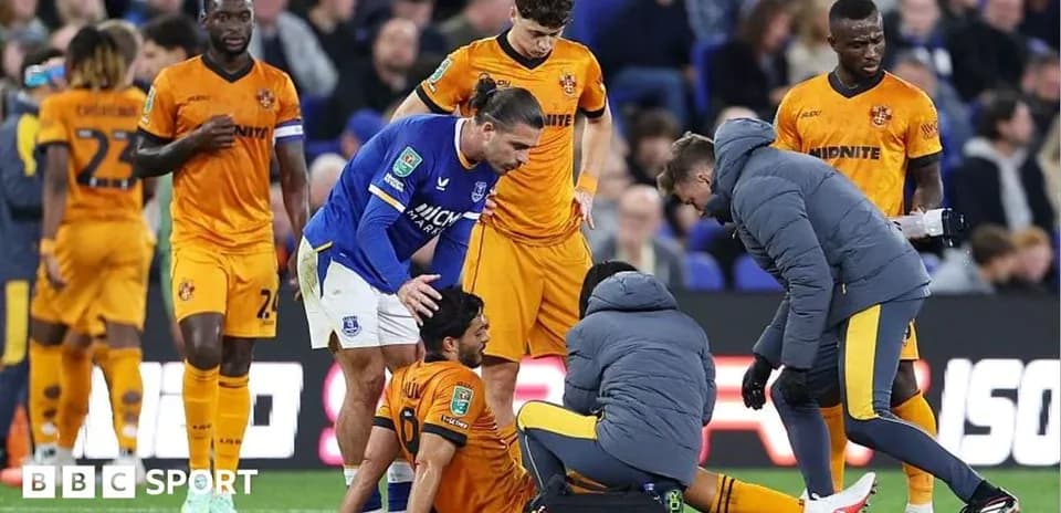 Players and medical staff attending to an injured player