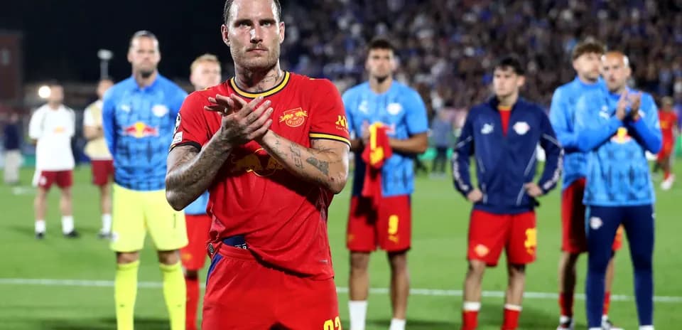 Player applauding with teammates in background