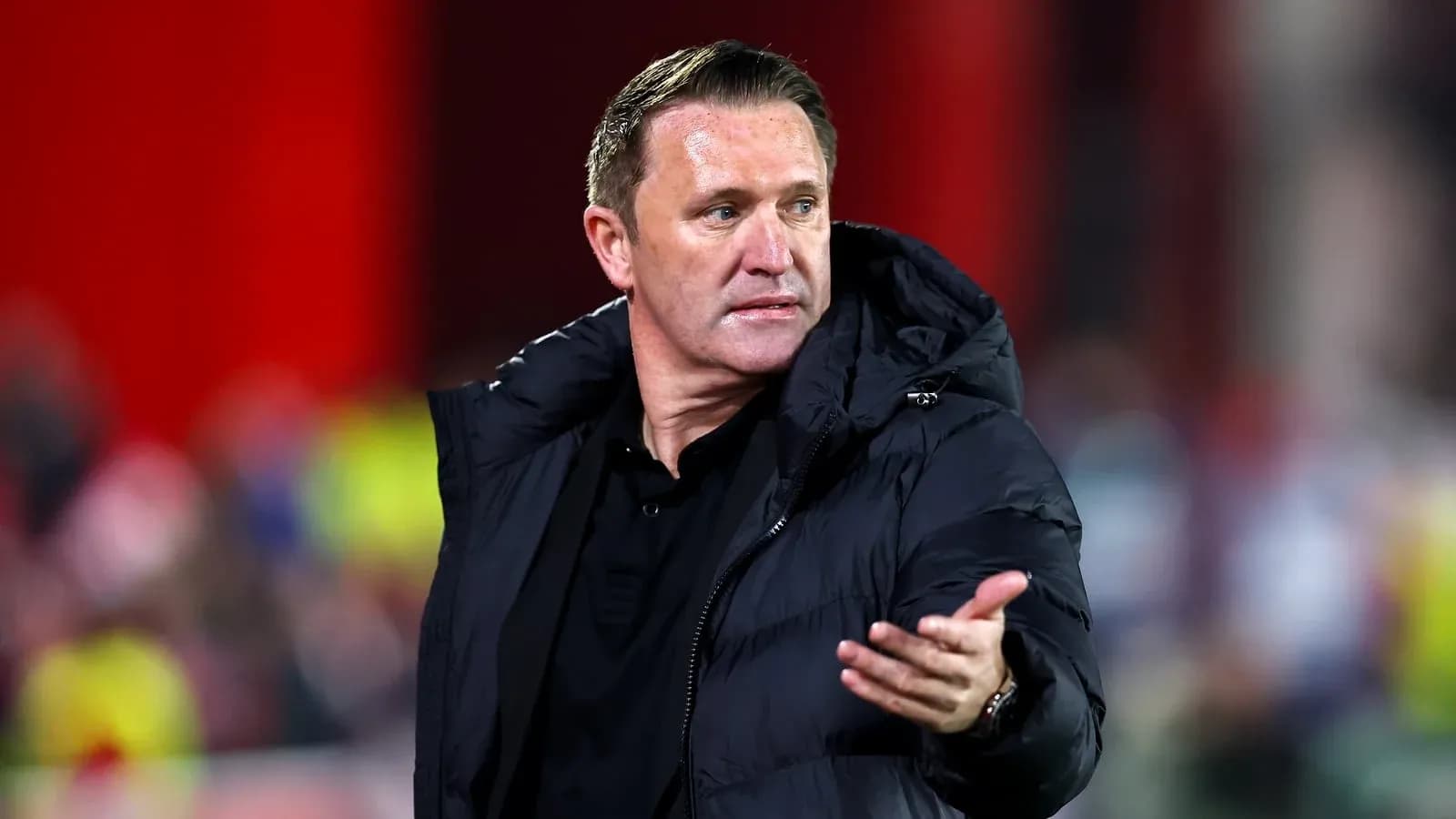 Coach gesturing during a football match
