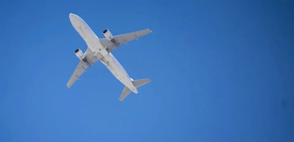 Airplane flying against clear blue sky
