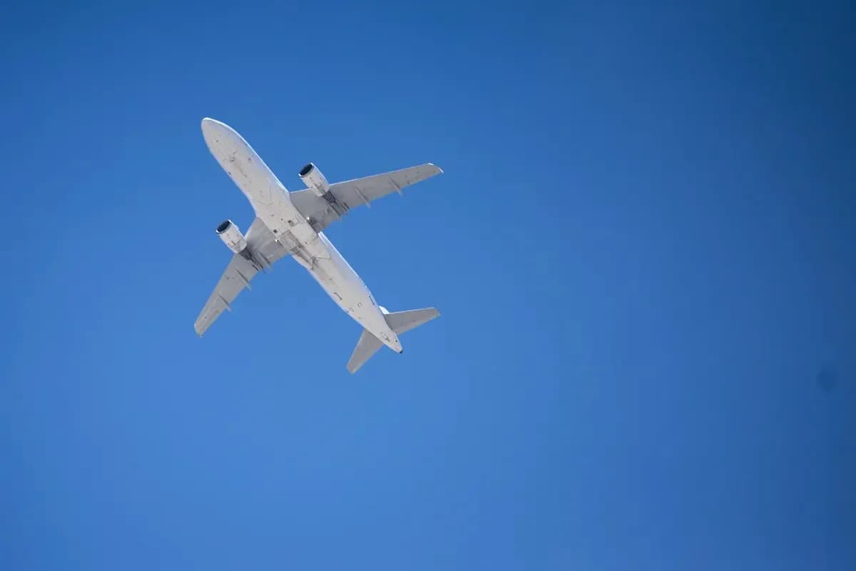 Airplane flying against clear blue sky