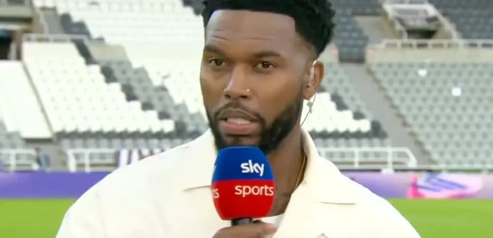 Presenter speaking into microphone on stadium field